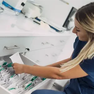 health care worker looking through files